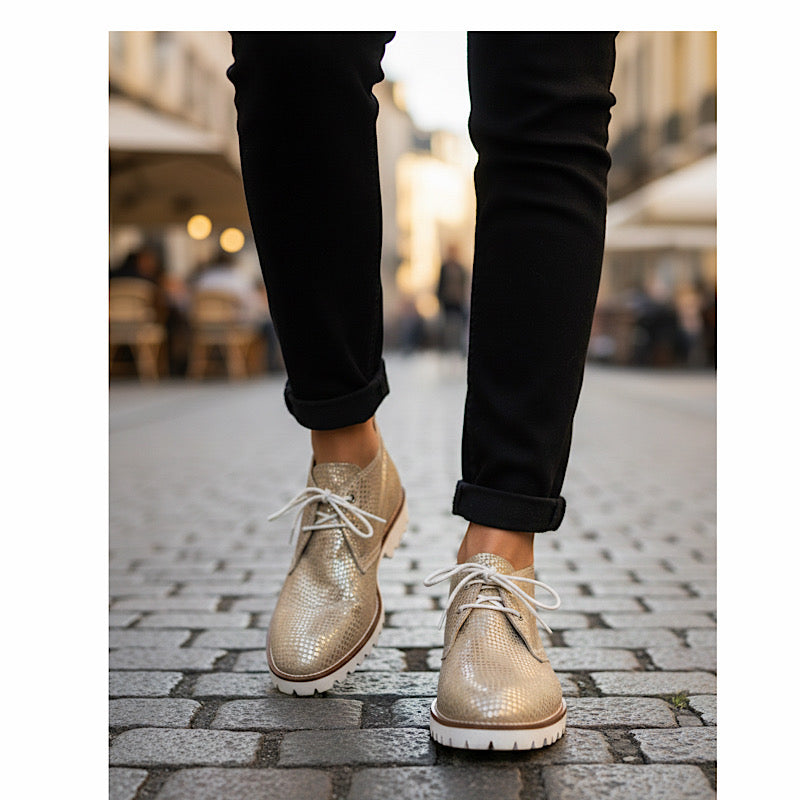 Gold leather ankle boots with a reptile print.